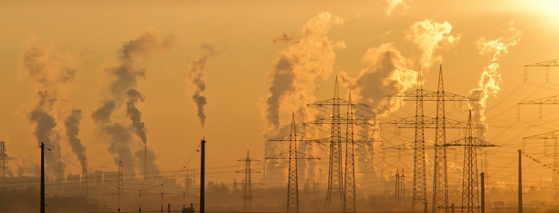 Photo of an industrial complex with gasses coming out of plants