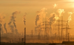 Photo of an industrial complex with gasses coming out of plants