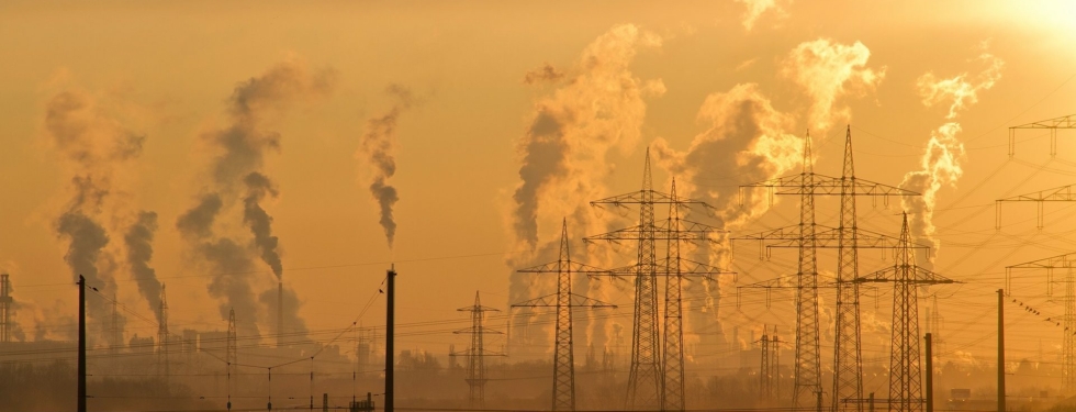 Photo of an industrial complex with gasses coming out of plants