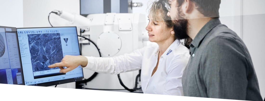 A woman and a men in front of a samples monitor