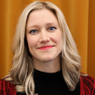Close up portrait of blonde woman against a yellow background, Anna Sandahl, communication officer at industry office at MAX IV