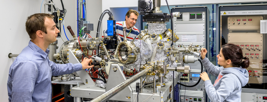 A small group of scientists in front of the MAXPEEM beamline