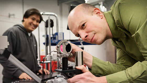 A picture of a scientist readjusting a prism
