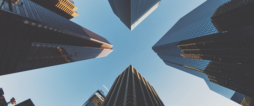 Big skyscrapers reaching towards a blue sky in the middle