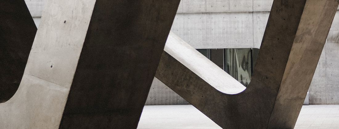 Grey concrete blocks in a concrete building with dark shadows.